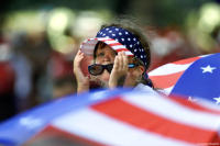 Young girl watches the Independence Day parade along Constitution Avenue.