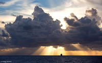 A cruise ship sails eastward following a storm in the Caribbean.