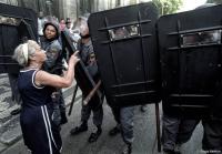 Elderly woman berates Police during violent protests in Rio.