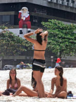 Santa Claus keeps an eye on sunbathers at Copacabana Beach.