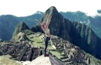 A visitor stretches at the Inca sanctuary of Machu Picchu in Peru.