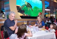 Family dining with 'Crush' aboard the Disney Dream cruise ship.