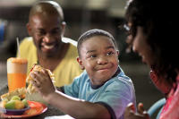 A youngster approves of his sandwich.