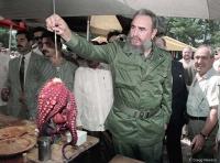 Cuban leader Fidel Castro with a local delicacy in Spain.