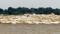 A boat is capsized in the maelstrom of the Pororoca on the Amazon River.