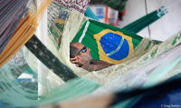 A riverboat traveler relaxes while traversing the mighty Amazon.