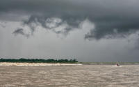 Jet ski pilot and surfer during a dangerous storm on the Amazon River.