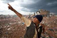 Youth strikes a pose while scavenging at a waste dump in Brazil.