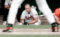 Orioles baseball star Cal Ripken Jr. observes a teammate's at-bat.