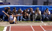 News photographers squeeze in to record Olympic champion Maurren Maggi.