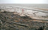 Another improvised field along a debris-ridden shore of the Amazon River.