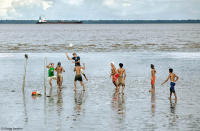 Playing at low tide on the muddy riverbed of the mighty Amazon.