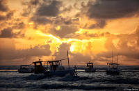Idle fishing boats at sunrise in Bahia.