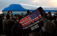 Supporters of President Trump observe his arrival in Florida aboard Air Force One.