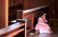 Young girl with a bouquet before a wedding ceremony.